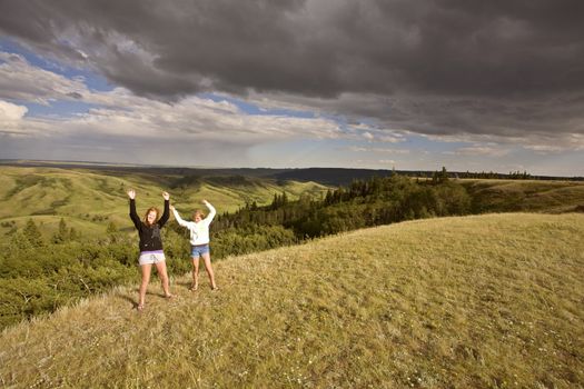 Cypress Hiils Canada conglomerate cliffs Saskatchewan view 2 girls arms in air