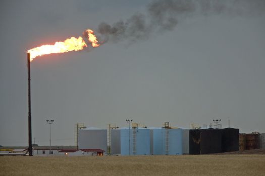 Oil Field  flame burn off gas oil jack well pump