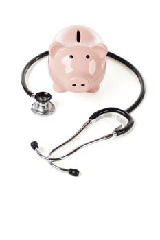 Piggy Bank and Stethoscope Isolated on a White Background.
