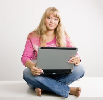 blonde with long beautiful hair with a laptop
