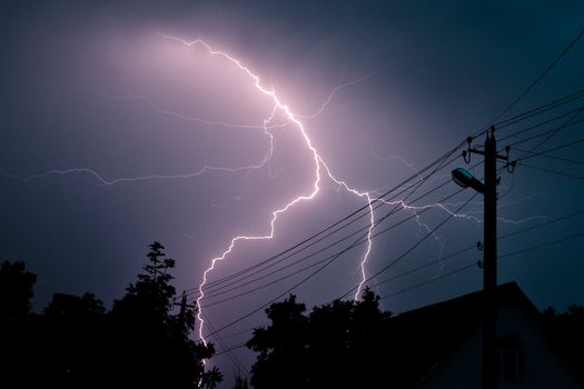 Lightning strike over a countryside house