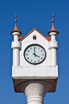 Round analog clock in a park