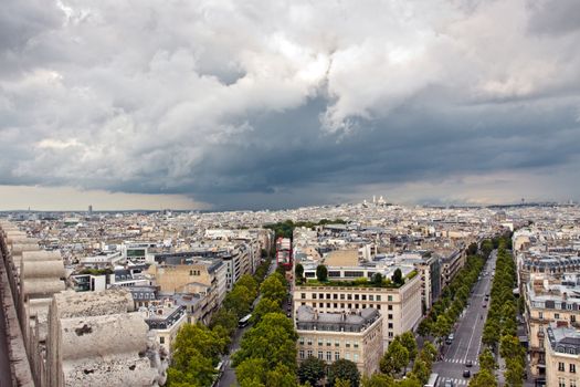 Paris aerial view with clouds from Triumphal Arch