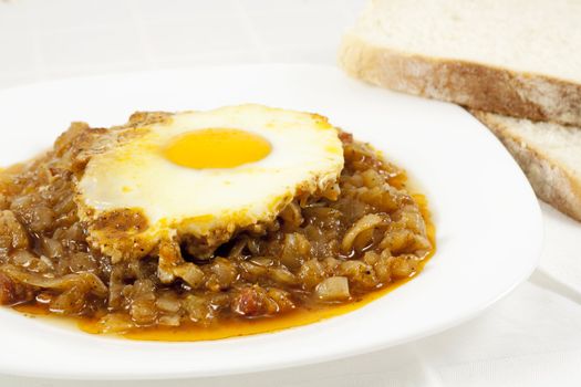 Delicious stew with baked onion, egg and meat