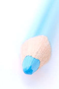 Closeup of a blue crayon isolated on a white backgrund. Has a shallow depth of field.