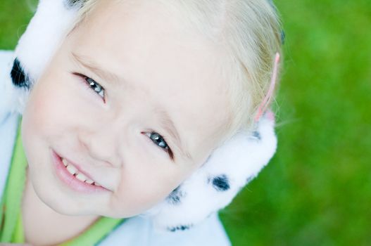 Shot of little girl in headphones playing outside