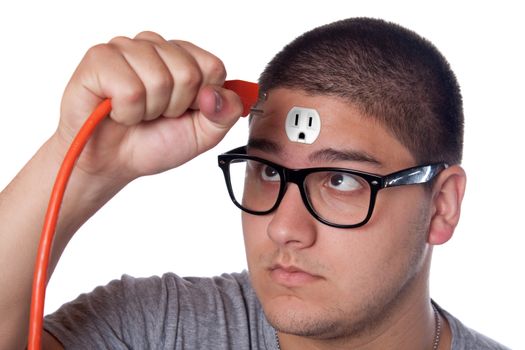 Conceptual image of a young man holding an electrical chord unplugged from the outlet on his forehead.