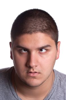 A young man that looks very tired and cross eyed with his eyes looking upward towards his forehead.