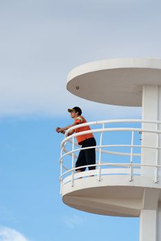 Lifeguard on duty on top of a watch-tower