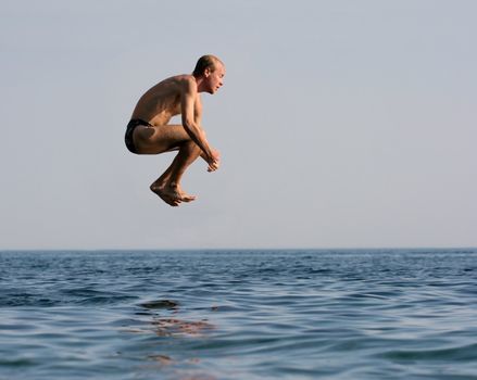 Man jumping into the see