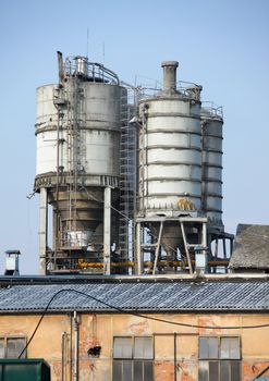 Old, abandoned industrial structure against clear blue sky