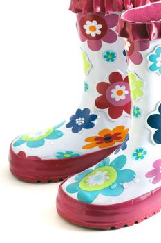 Fun little girl's colorful flower rain boots isolated on white.