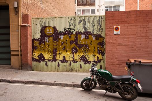 The gate with city graffiti. Barcelona, Spaine