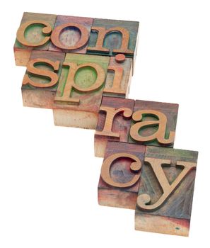 conspiracy word in vintage wood letterpress printing blocks, stained by color inks, isolated on white