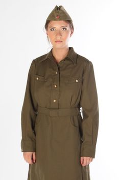The young and beautiful girl in a military dress and a field cap