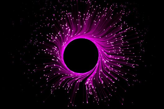 Many dark pink illuminated fiber optic light strands in a ring formation against black.