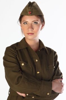 The young and beautiful girl in a military dress and a field cap