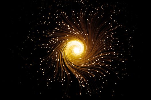Many illuminated golden fiber optic light strands swirling towards the centre against a black background