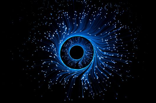 Illuminated blue fibre optic light strands forming swirling rings against a black background.