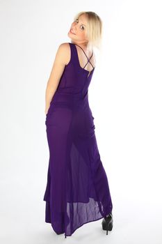 The young beautiful girl in a violet dress
