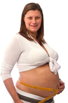 Pregnant woman measures her belly 