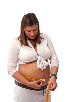 Pregnant woman measures her belly 