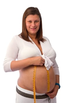Pregnant woman measures her belly 
