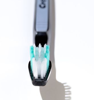 Macro image of toothbrush head with sharp bristles and out of focus handle