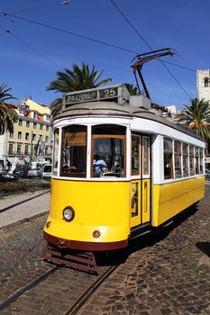 Typical yellow Tram in Lisbon street, Portugal 