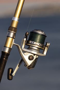 fishing reel on the beach with sunlight