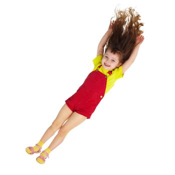A happy little girl falls down on a white background