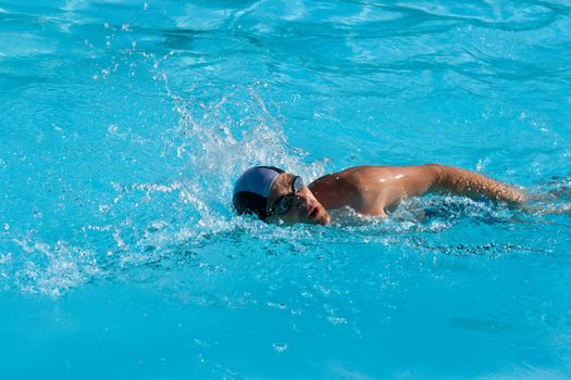 Athletic Man swimming in the pool