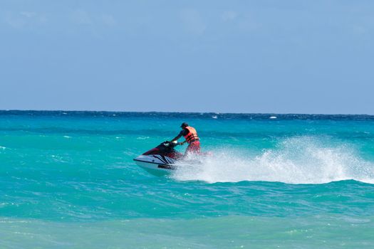 Man riding jet ski in Caribbean sea