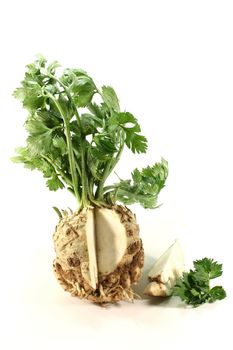 capped celery with green leaves on white background