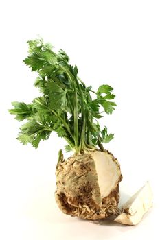 capped celery with green leaves on white background