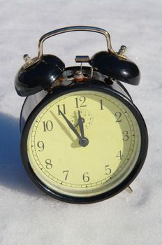 clock on a real snowy icy surface