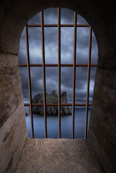 View on stormy ocean from a dungeon window