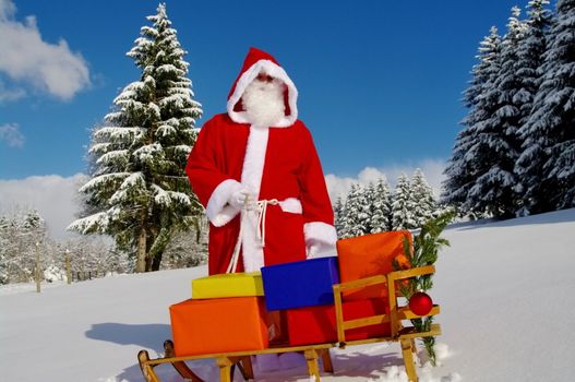 Santa Claus, Father Christmas with colorful presents on a sledge