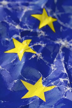 detail photo of wrinkled european union flag, three yellow stars
