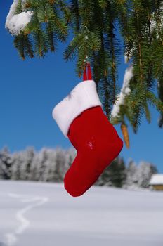 Santa Claus Christmas boot for gifts outside in a snowy landscape