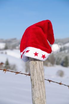 red santa claus hats in a snowy landscape