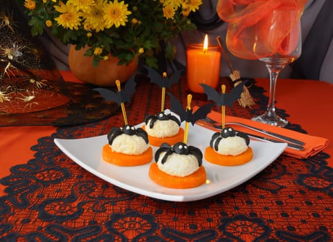  Cheese balls with olives spiders and bats on a festive table