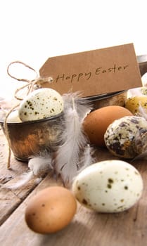 Brown speckled eggs  with easter card on wooden table