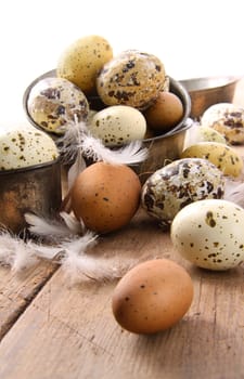 Brown and white speckled eggs on wooden table
