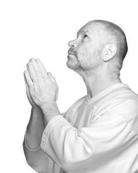 Senior man praying on white background in high key format