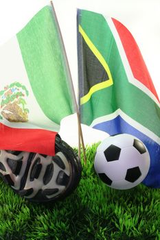 Flags with leather ball and soccer shoes on a white background