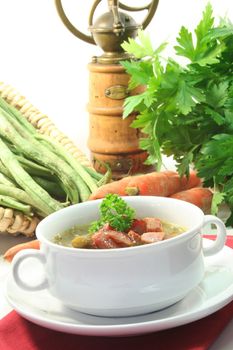 Green bean stew in a white soup cup