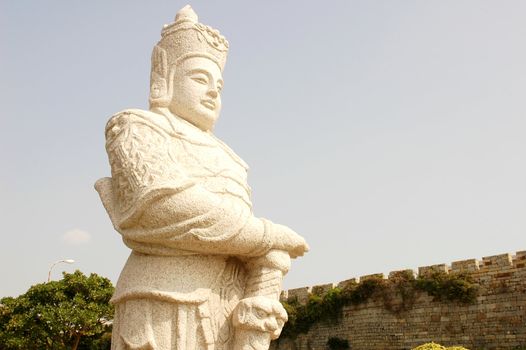 Stone statue of an ancient armed soldier