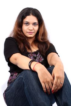 A portrait of a beautiful Indian lady, on white studio background.