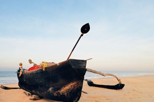 Wooden old fishing boat on the sandy shore